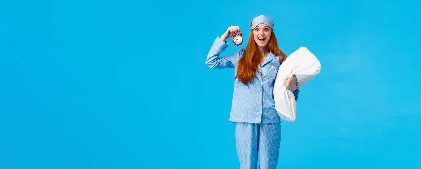 Full-length, vertical studio shot of an attractive, excited, happy, cheerful, upbeat girl in nightwear who just woke up.